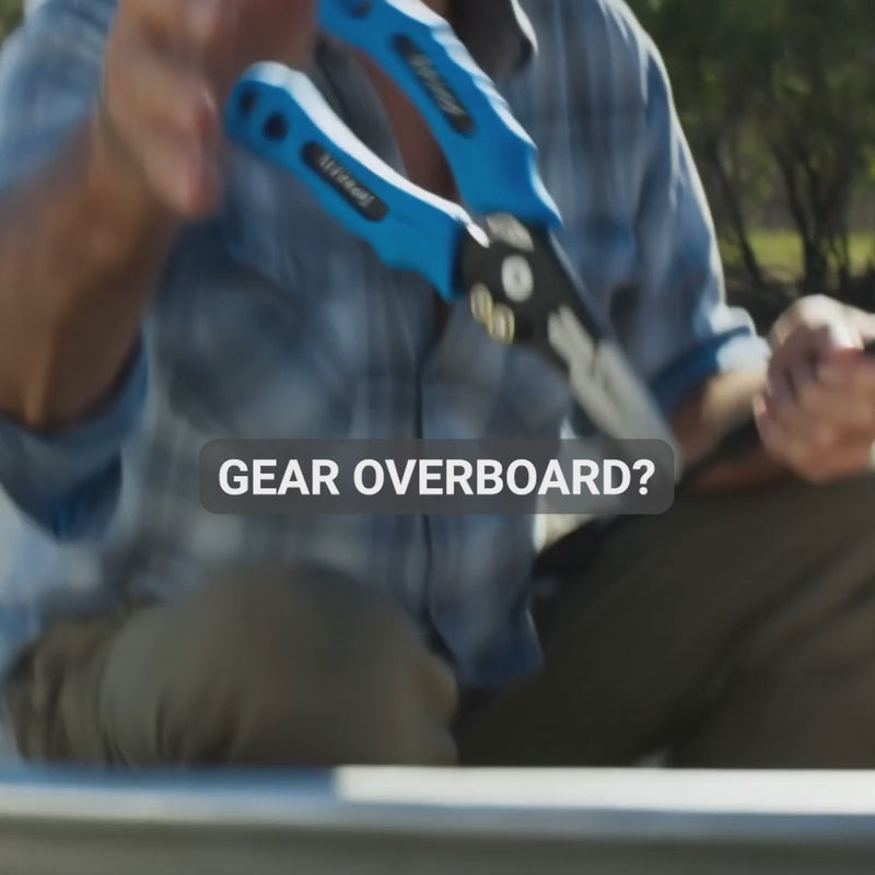 Fishing tool safety bungie tethering a pair of pliers to an angler's wrist, stopping the tool falling overboard